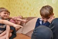 Children humiliate the boy and poke a finger at him in protest of communication