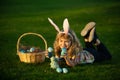 Children hunting easter eggs. Kid boy lying on the grass and finding egg. Child with easter eggs and bunny ears, outdoor Royalty Free Stock Photo