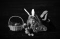 Children hunting easter eggs. Kid boy lying on the grass and finding egg. Child with easter eggs and bunny ears, outdoor Royalty Free Stock Photo