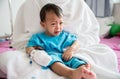 Children illness . Little Baby attaching intravenous tube to patient`s hand in hospital bed. Baby sick and crying on mom .