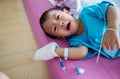 Children illness . Little Baby attaching intravenous tube to patient`s hand in hospital bed. Baby sick and crying on mom .