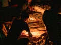 Children illuminating candles in the sand at the beach Royalty Free Stock Photo