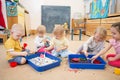 Children improving hands motor skills with rice and beans