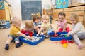 Children improving motor skills of hands with rice and beans