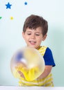 Children inflates a big bubble from a pink slime and yellow slime.