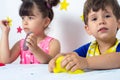 Children inflates a big bubble from a slime. Girl and boy play with slime.