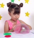 Children inflates a big bubble from a slime. Girl and boy play with slime.