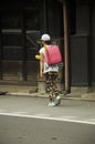 Children japanese girl walking go to back home after finished cl