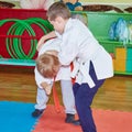 Children in judogi are training capture for a throw