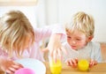 Children, juice and curious in home in the morning with food, kids and glass ready for eating. Family, dinner table and Royalty Free Stock Photo