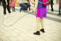 Children jump over a rope. Children`s holiday with an animator. Competition for preschoolers on the square Royalty Free Stock Photo