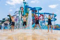 Children jump up happily at a water fountain at Cartoon Network Royalty Free Stock Photo