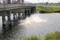 Children jumping from a bridge during hot summer in the Netherlands at the Row facility Willem-Alexanderbaan.