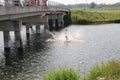 Children jumping from a bridge during hot summer in the Netherlands at the Row facility Willem-Alexanderbaan.