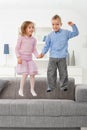 Children jumping on couch