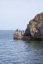 Children jumping into the sea at Babbacombe Beach in Torbay, Devon in the UK