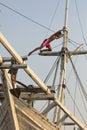 Children jumping into the water from the wooden boats in Jakarta harbor