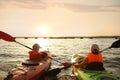 Little children kayaking on river, back view. Summer camp activity Royalty Free Stock Photo