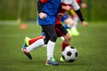 Children Kicking Soccer Ball on Grass Field. Two School Kids Running in a Duel Royalty Free Stock Photo