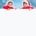 Children kids girl boy Christmas Santa Claus pointing happy empty banner copyspace copy space Royalty Free Stock Photo