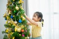 Children kids girl decorating christmas tree for celebrate christmas and new year party at home. Preparing for holiday. Happiness Royalty Free Stock Photo