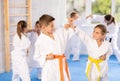 Children in kimono practicing karate in sports gym. Martial arts training session Royalty Free Stock Photo