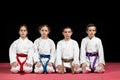 Children in kimono sitting on tatami on martial arts seminar. Selective focus Royalty Free Stock Photo