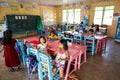 Children in Kindergarten, Philippines, Little girls and boys sitting on colorful chairs. Kids have a break at Kindergarten. Royalty Free Stock Photo