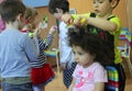 Children in kindergarten playing the barber
