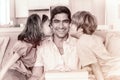 Children kissing on fathers cheeks