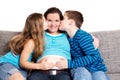 Children kissing their pregnant mother Royalty Free Stock Photo