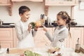 Children in kitchen. Brother is holding peppers and sister is choosing. Royalty Free Stock Photo