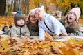 Children from a large family, four happy children lie on a plaid blanket in an autumn park Royalty Free Stock Photo