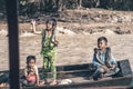 Children with large python snakes on the wooden boat at the Tonle Sap lake in Cambodia 2019-12-27. The floating village Royalty Free Stock Photo