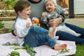 Children laughing and having picnic outside in the vegetable garden Royalty Free Stock Photo