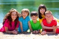 Children laughing by lake