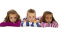 Children laying down wearing pajamas looking at camera Royalty Free Stock Photo