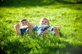 Children laying on grass. Family picnic in spring park Royalty Free Stock Photo