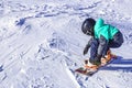 Children learn to snowboard on the mountainside on a clear day Royalty Free Stock Photo