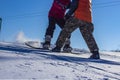 Children learn to snowboard on the mountainside on a clear day Royalty Free Stock Photo