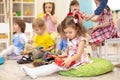 Children learning musical instruments on lesson in kindergarten