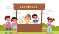 Children lemonade. Happy kids make lemon drink, little sellers behind the counter outdoor, boys and girls buy fruit Royalty Free Stock Photo