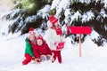 Children with letter to Santa at Christmas mail box in snow Royalty Free Stock Photo
