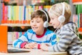 Children in a library listening to audio books Royalty Free Stock Photo
