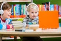 Children in a library listening to audio books Royalty Free Stock Photo