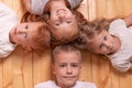 Children lie on the floor and looking at camera . portrait of brothers and sisters. red children