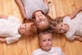 Children lie on the floor and looking at camera . portrait of brothers and sisters. red children