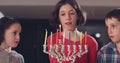 Children lighting Hanukka candles at home