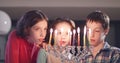 Children lighting Hanukka candles at home