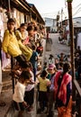 Children line up on stairs, balcony and street to watch foreigners here to film them
